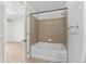 Bathroom featuring a bathtub with tile surround and a view to the bedroom at 4100 Albion St # 614, Denver, CO 80216
