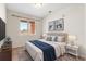 Tastefully decorated bedroom featuring a comfortable bed, artwork, and a window with blinds at 4100 Albion St # 614, Denver, CO 80216