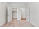 Bedroom showcasing doorways to a walk-in closet and the bathroom, with neutral carpet at 4100 Albion St # 614, Denver, CO 80216