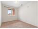 Bright, empty bedroom with neutral carpet and a window providing natural light at 4100 Albion St # 614, Denver, CO 80216