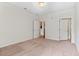 Spacious bedroom with neutral carpet, featuring two doorways leading to other areas of the home at 4100 Albion St # 614, Denver, CO 80216