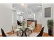 Cozy dining room leading into kitchen area with hardwood floors and bright lighting at 4100 Albion St # 614, Denver, CO 80216