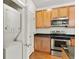 Well-equipped kitchen with washer and dryer, stainless steel appliances, and granite countertops at 4100 Albion St # 614, Denver, CO 80216