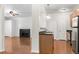 Bright living room flows into the kitchen with hardwood floors and fireplace at 4100 Albion St # 614, Denver, CO 80216