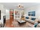 Bright living room featuring hardwood floors, a cozy fireplace, and an open layout at 4100 Albion St # 614, Denver, CO 80216