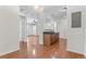 Spacious living room with hardwood floors flows into kitchen area at 4100 Albion St # 614, Denver, CO 80216