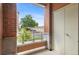 Patio view showcasing the building's brick exterior, landscaping, and distant parking areas at 4100 Albion St # 614, Denver, CO 80216