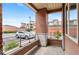 Inviting porch featuring brick columns and views of the well-maintained exterior and parking at 4100 Albion St # 614, Denver, CO 80216