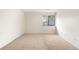 A bedroom with neutral-toned walls and carpet, with a window providing natural light at 3041 S Ursula Cir # 302, Aurora, CO 80014