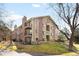 Multi-story condo building featuring brick and siding, balconies, and professionally landscaped grounds at 3041 S Ursula Cir # 302, Aurora, CO 80014