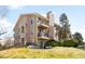 Attractive multi-story condo building with a brick chimney, balconies, and lush landscaping at 3041 S Ursula Cir # 302, Aurora, CO 80014