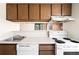 Galley kitchen featuring white countertops, wood cabinets, and basic appliances at 3041 S Ursula Cir # 302, Aurora, CO 80014