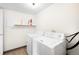 Well-lit laundry room featuring a washer and dryer and a handy fire extinguisher on the shelf at 3041 S Ursula Cir # 302, Aurora, CO 80014