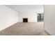 Spacious carpeted living room with a fireplace and a sliding glass door to the balcony at 3041 S Ursula Cir # 302, Aurora, CO 80014