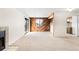 Cozy living room featuring wood accent wall, neutral carpet, and access to the kitchen at 3041 S Ursula Cir # 302, Aurora, CO 80014