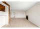 Open-concept living room with neutral carpet, fireplace, and view of the entrance hall at 3041 S Ursula Cir # 302, Aurora, CO 80014