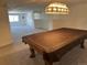 Open finished basement with neutral carpet, a pool table and decorative lighting at 11237 W 55Th Ln, Arvada, CO 80002