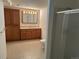 Bathroom features a vanity with ample storage, framed mirror and a tiled shower stall at 11237 W 55Th Ln, Arvada, CO 80002