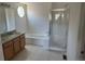 Well-lit bathroom featuring a shower, tub, granite vanity, and tile flooring at 11237 W 55Th Ln, Arvada, CO 80002