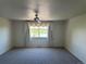 Bright, spacious bedroom featuring neutral carpet, a ceiling fan, and a view of the lake at 11237 W 55Th Ln, Arvada, CO 80002