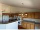 Bright kitchen featuring wooden cabinetry, granite countertops, and stainless steel appliances at 11237 W 55Th Ln, Arvada, CO 80002