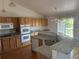Bright kitchen featuring granite countertops, stainless steel appliances, and hardwood floors at 11237 W 55Th Ln, Arvada, CO 80002