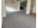Spacious living room featuring neutral carpet, white walls, and a chandelier at 11237 W 55Th Ln, Arvada, CO 80002
