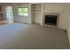 Bright living room featuring neutral carpet, a fireplace, and a large window at 11237 W 55Th Ln, Arvada, CO 80002