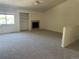 Cozy living room featuring neutral carpet and a fireplace with decorative shelving at 11237 W 55Th Ln, Arvada, CO 80002