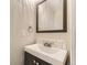 Powder room features a modern sink, vanity, and a square mirror at 8243 S Fillmore Cir, Centennial, CO 80122