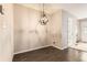 Minimalist dining room featuring hardwood floors, a modern chandelier, and neutral colored walls at 8243 S Fillmore Cir, Centennial, CO 80122