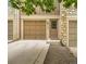 Inviting exterior featuring a brown garage door, matching front door, and stone accents at 8243 S Fillmore Cir, Centennial, CO 80122