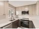 Bright kitchen showcasing modern appliances, ample counter space, and a window for natural light at 8243 S Fillmore Cir, Centennial, CO 80122