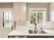 Bright kitchen featuring a stainless steel sink, modern cabinets, and a view to the outside at 8243 S Fillmore Cir, Centennial, CO 80122