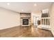 Spacious living room with a stone fireplace, hardwood floors, and staircase to the upper level at 8243 S Fillmore Cir, Centennial, CO 80122