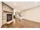 Inviting living room with a stone fireplace and hardwood floors, with stairs and kitchen access at 8243 S Fillmore Cir, Centennial, CO 80122