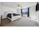 Primary bedroom featuring a white bed frame, ceiling fan and natural light at 14828 E 118Th Pl, Commerce City, CO 80603