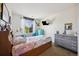 Bright bedroom featuring a large window, vanity and modern decor at 14828 E 118Th Pl, Commerce City, CO 80603