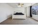 Primary bedroom with ceiling fan, neutral walls and a large window with privacy blinds at 14828 E 118Th Pl, Commerce City, CO 80603