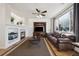 Inviting living room with fireplace, mounted tv, aquarium, hardwood floors, and a comfortable leather sofa at 14828 E 118Th Pl, Commerce City, CO 80603