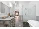 Beautiful bathroom featuring a glass shower, soaker tub, and a vanity with eye catching geometric flooring at 624 E 18Th Ave # 4, Denver, CO 80203
