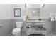 Modern bathroom featuring black and white tiled floors, and a mirrored vanity at 624 E 18Th Ave # 4, Denver, CO 80203
