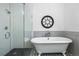 Bathroom with a clawfoot tub, a glass enclosed shower, and black and white tiled floors at 624 E 18Th Ave # 4, Denver, CO 80203