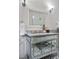Close up of the bathroom vanity with marble countertop, decorative mirror, and patterned tile flooring at 624 E 18Th Ave # 4, Denver, CO 80203