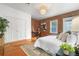 Inviting bedroom with exposed brick wall, hardwood floors, and ample natural light at 624 E 18Th Ave # 4, Denver, CO 80203