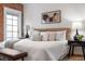 Bright bedroom features exposed brick and stylish furniture against a light, neutral color palette at 624 E 18Th Ave # 4, Denver, CO 80203