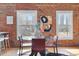 Bright dining room with a table, chairs, exposed brick and city views at 624 E 18Th Ave # 4, Denver, CO 80203