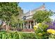 Beautiful home with lush landscaping, mature trees, and a charming front porch at 624 E 18Th Ave # 4, Denver, CO 80203