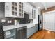 Updated kitchen featuring white cabinets, a stainless steel dishwasher, and a farmhouse sink at 624 E 18Th Ave # 4, Denver, CO 80203
