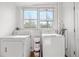 Laundry room with stacked white washer and dryer and a window providing natural light at 624 E 18Th Ave # 4, Denver, CO 80203